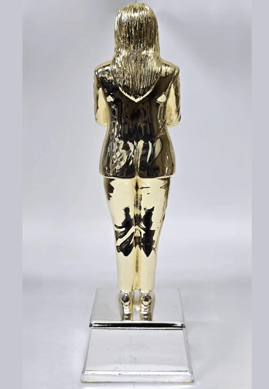 A gold and silver "World's Best Mom" trophy featuring a woman in a suit with arms crossed. back