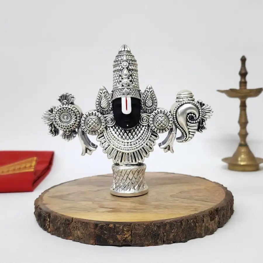 Antique Silver-finish Lord Balaji idol with black face placed on a wooden base.front view 4.5 inch