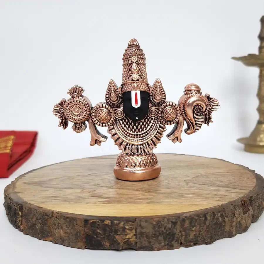 Antique copper-finish Lord Balaji idol with black face on wooden base. front