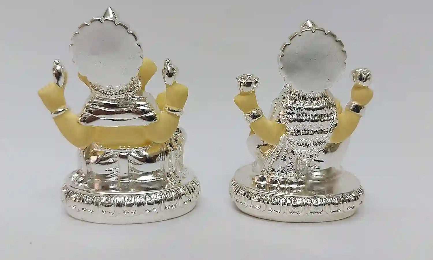 Back view of Lakshmi and Ganesha resin idol set, showcasing silver plating with subtle off-white detailing and handcrafted finish