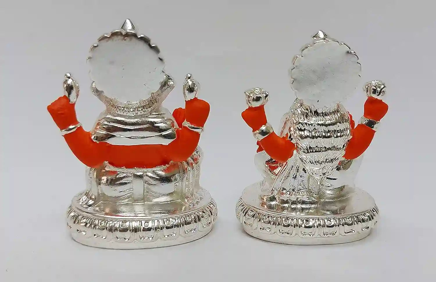 Back view of Lakshmi and Ganesha resin idol pair, gold plated with silver-orange detailing, showing intricate handcrafted finish and premium resin artistry