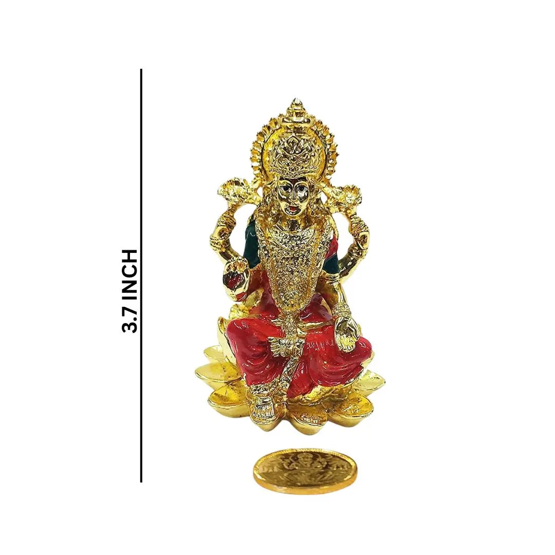 Compact 3.7-inch Kamal Lakshmi idol with orange enamel work, placed on lotus base, shown with gold-plated coin for size reference.