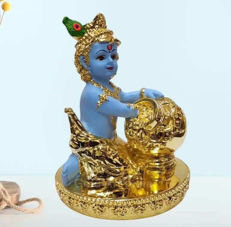 Gold-plated Makhan Krishna idol with blue skin, sitting with a butter pot