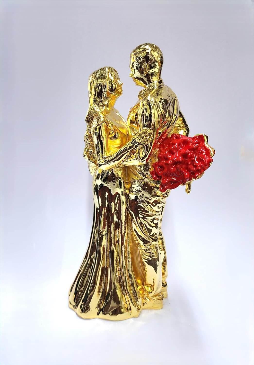 Gold-plated romantic couple figurine holding a Red rose bouquet