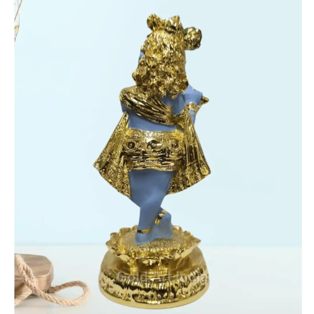 Gold-plated Krishna idol playing the flute, beautifully designed with a blue body and golden ornaments, standing on a decorative base