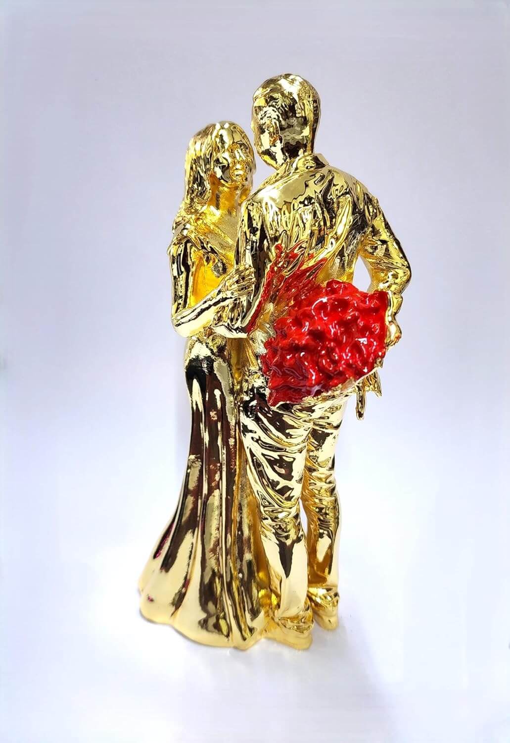 Gold-plated romantic couple figurine holding a Red rose bouquet