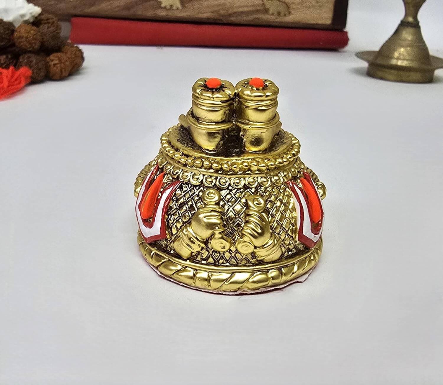 Angled close-up of Hanuman Ji Paduka placed on a wooden dashboard background