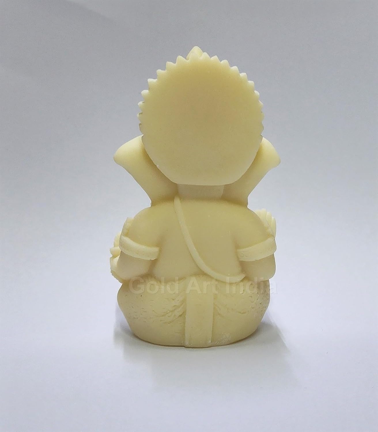 A 3.5-inch Ivory_Finish Ganesha statue with a crown, jewelry back side