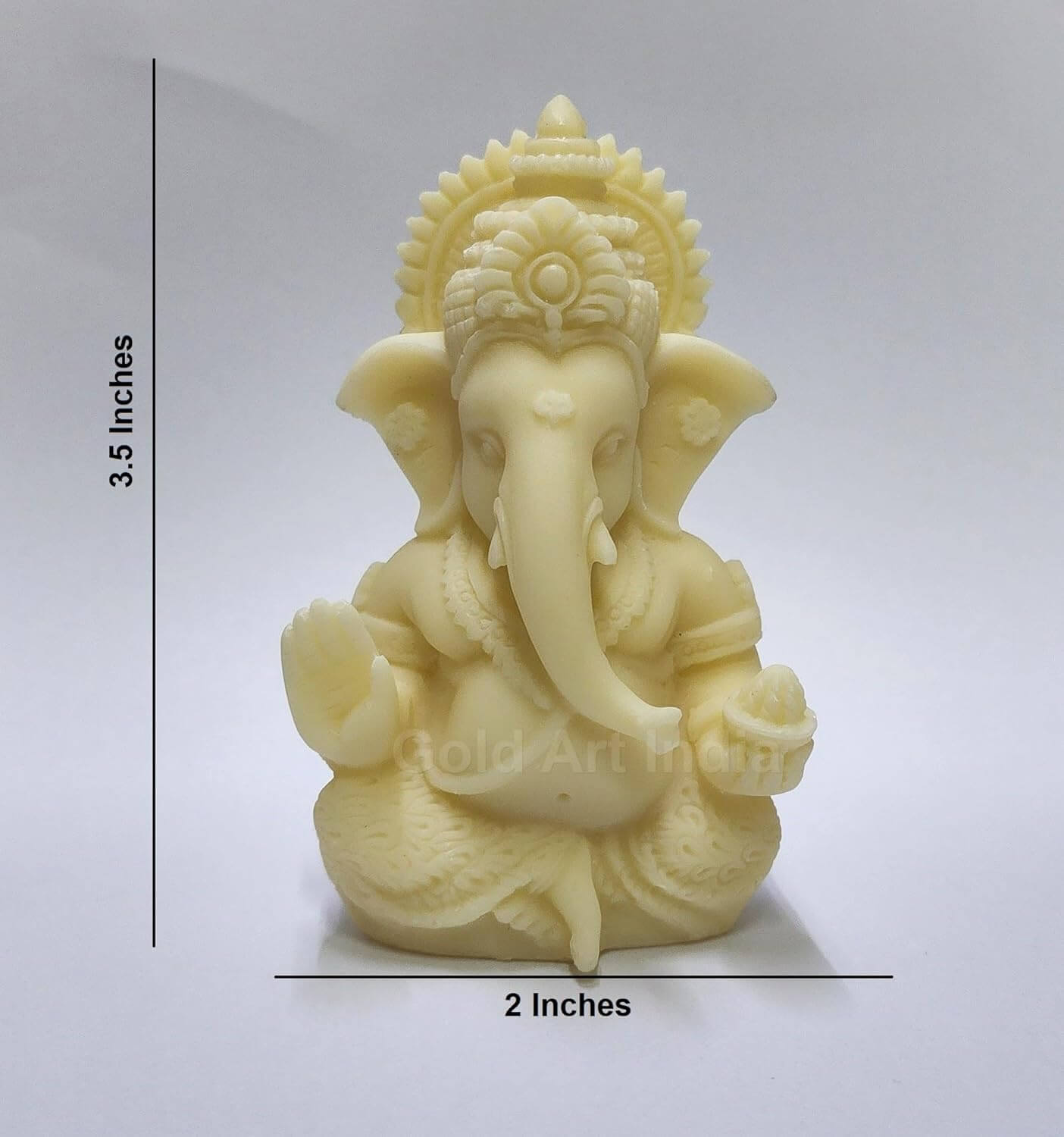 A 3.5-inch Ivory_Finish Ganesha statue with a crown, jewelry, and intricate carvings. One hand gives blessings, the other holds a modak.