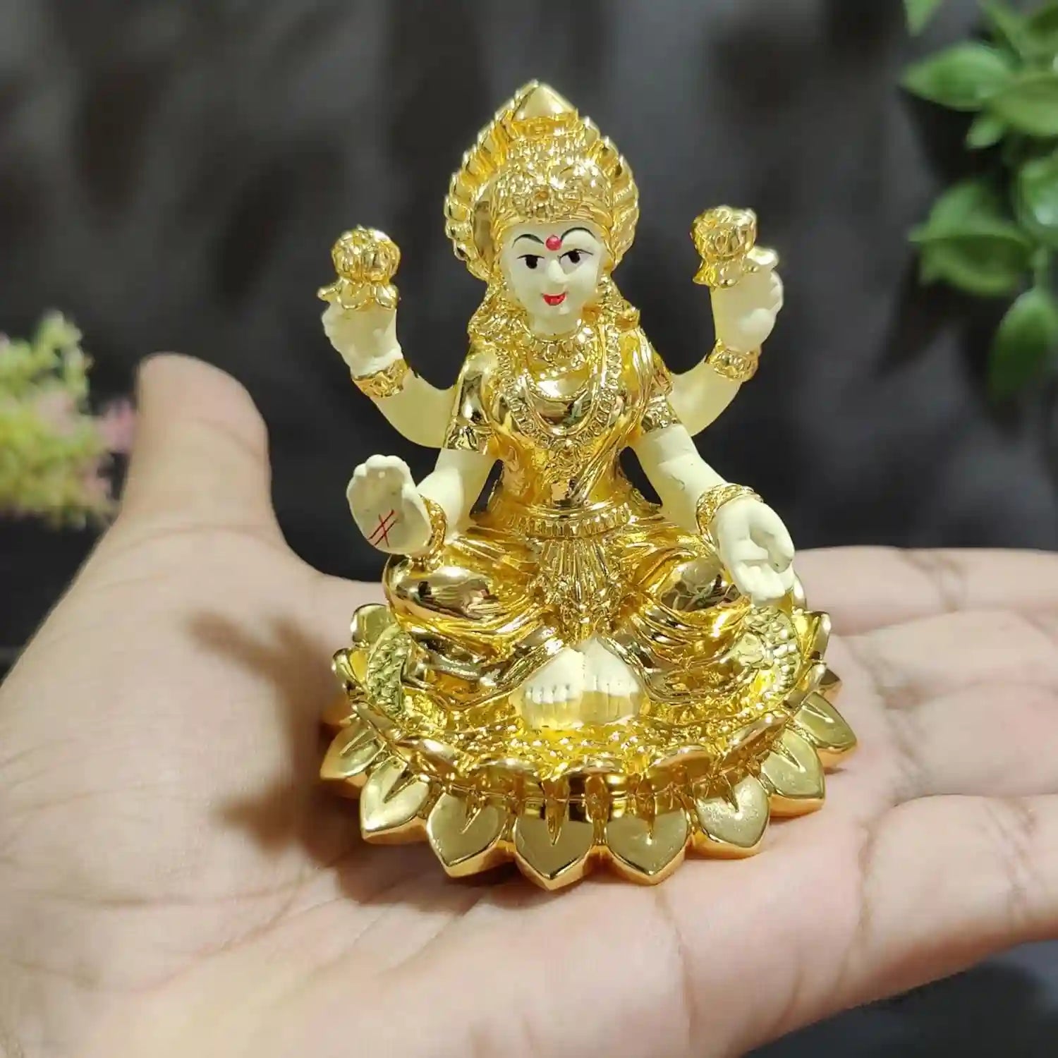 Side view of Kamal Laxmi Idol with gold finish, shown in hand for size reference | Gold Art India