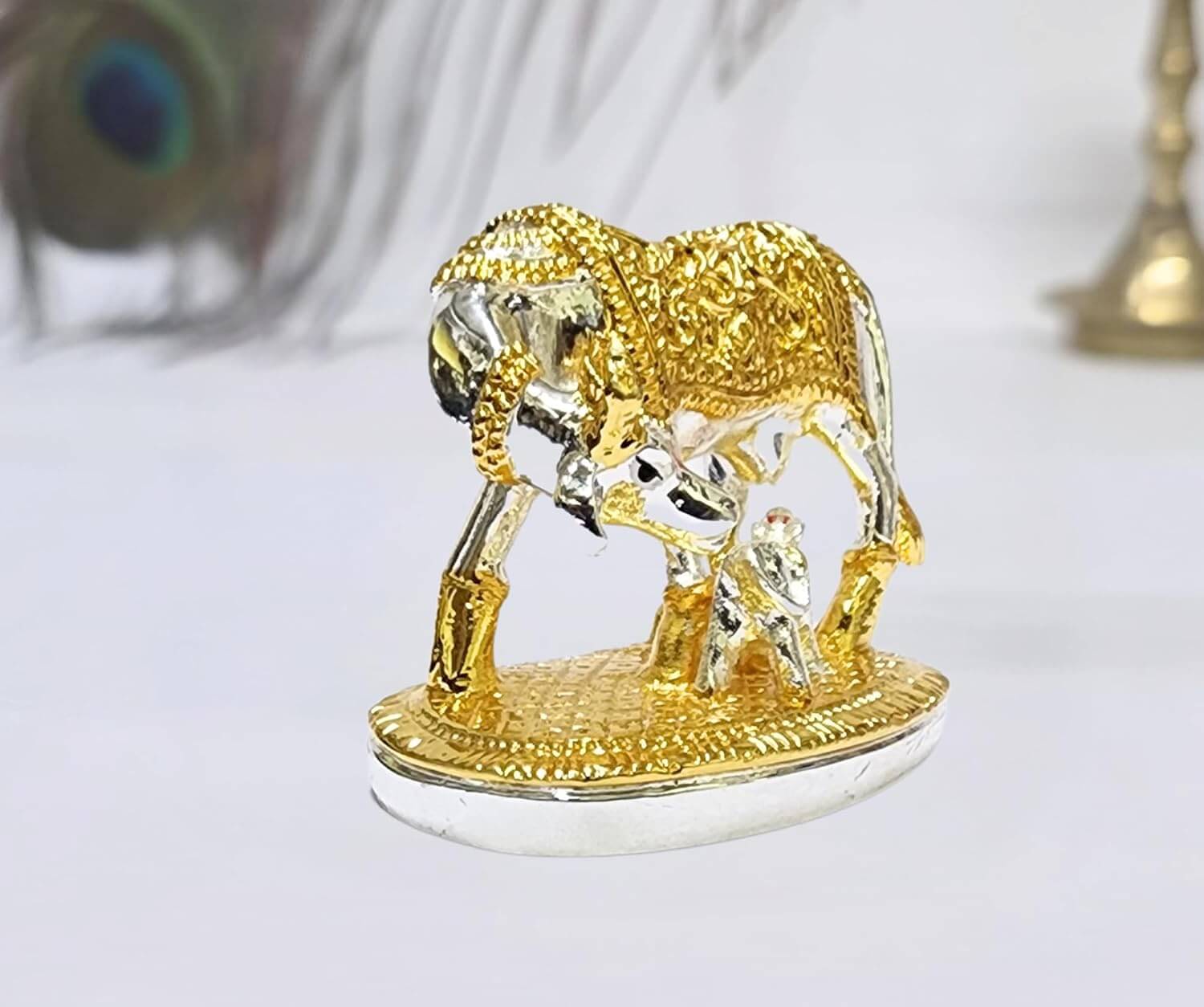 Gold Art India elegant silver and gold
Plated Kamadhenu cow and calf idol with intricate detailing, symbolizing prosperity and spiritual blessings. Perfect for home decor, puja rituals, and gifting