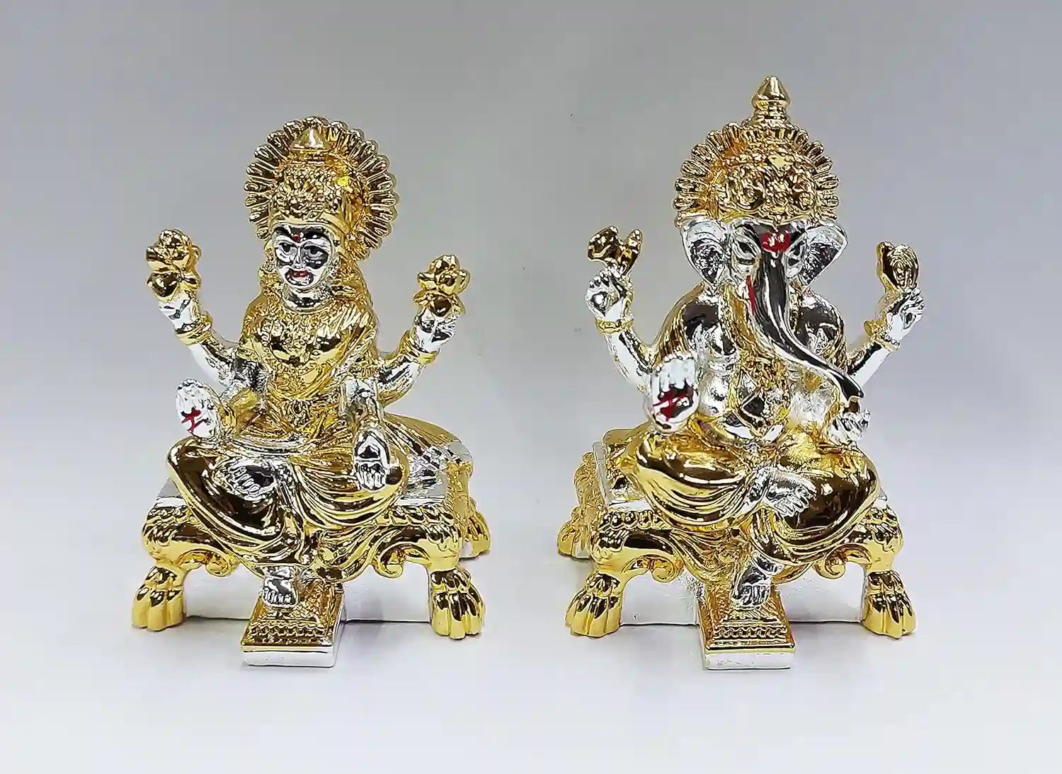Handcrafted resin Lakshmi and Ganesha idol with gold and silver plated multicolour finish, placed on white background