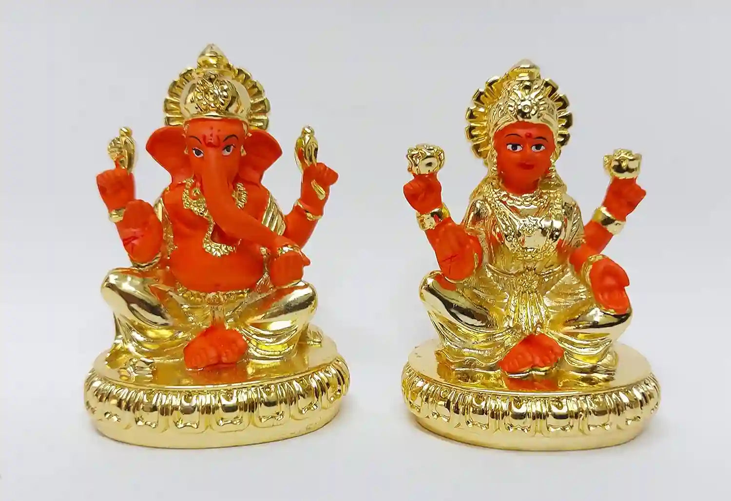 Handcrafted Lakshmi and Ganesha resin idols, gold plated with gold-orange detailing, elegant design for car dashboard, home décor, or gifting