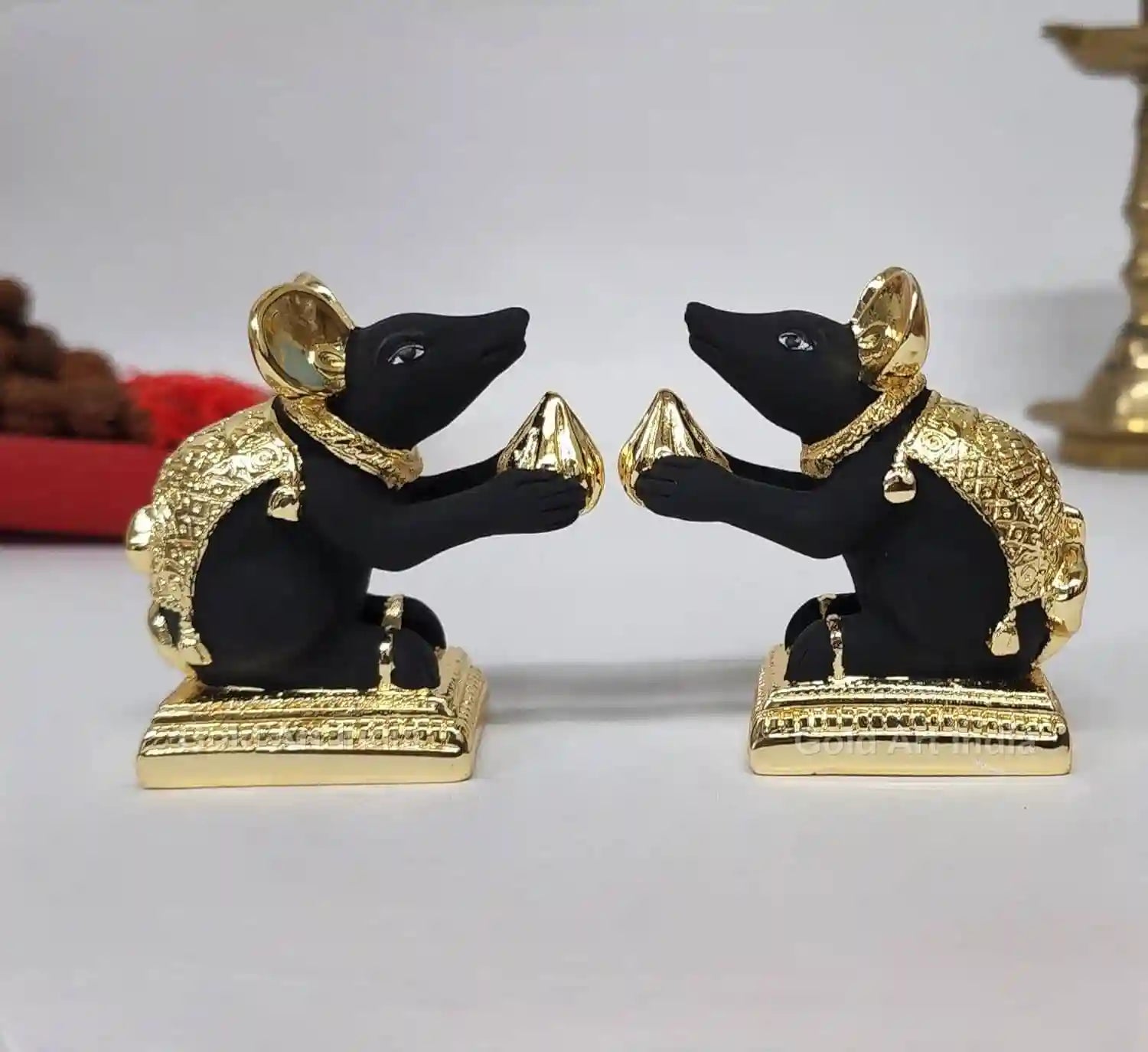 Gold-plated & Black Terracotta Mushak Pair rat idol with intricate carvings, sitting on a decorative base, holding a modak offering in its paws