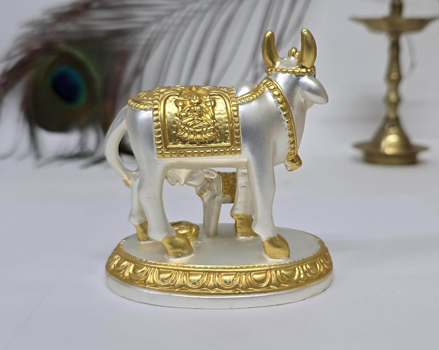 Rear view of Kamdhenu cow idol showing intricate detailing and two-tone plating