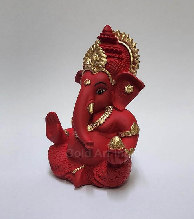 Lord Ganesha statue in maroon red terracotta finish with golden detailing, perfect for home and car decor.