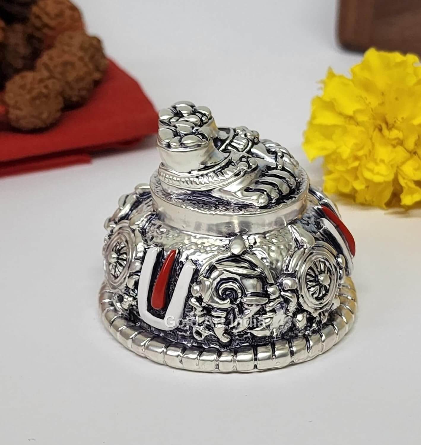 A silver Plated decorative idol featuring Lord Balaji's feet (Paduka) with intricate carvings of religious symbols and ornaments.