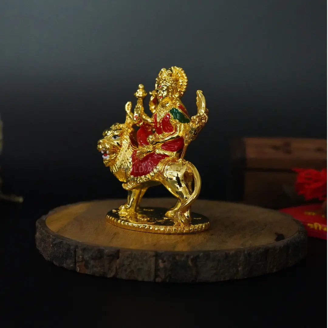 Side angle of small 3.6-inch Gold Plated Maa Durga Idol riding lion with red enamel clothing | Gold Art India