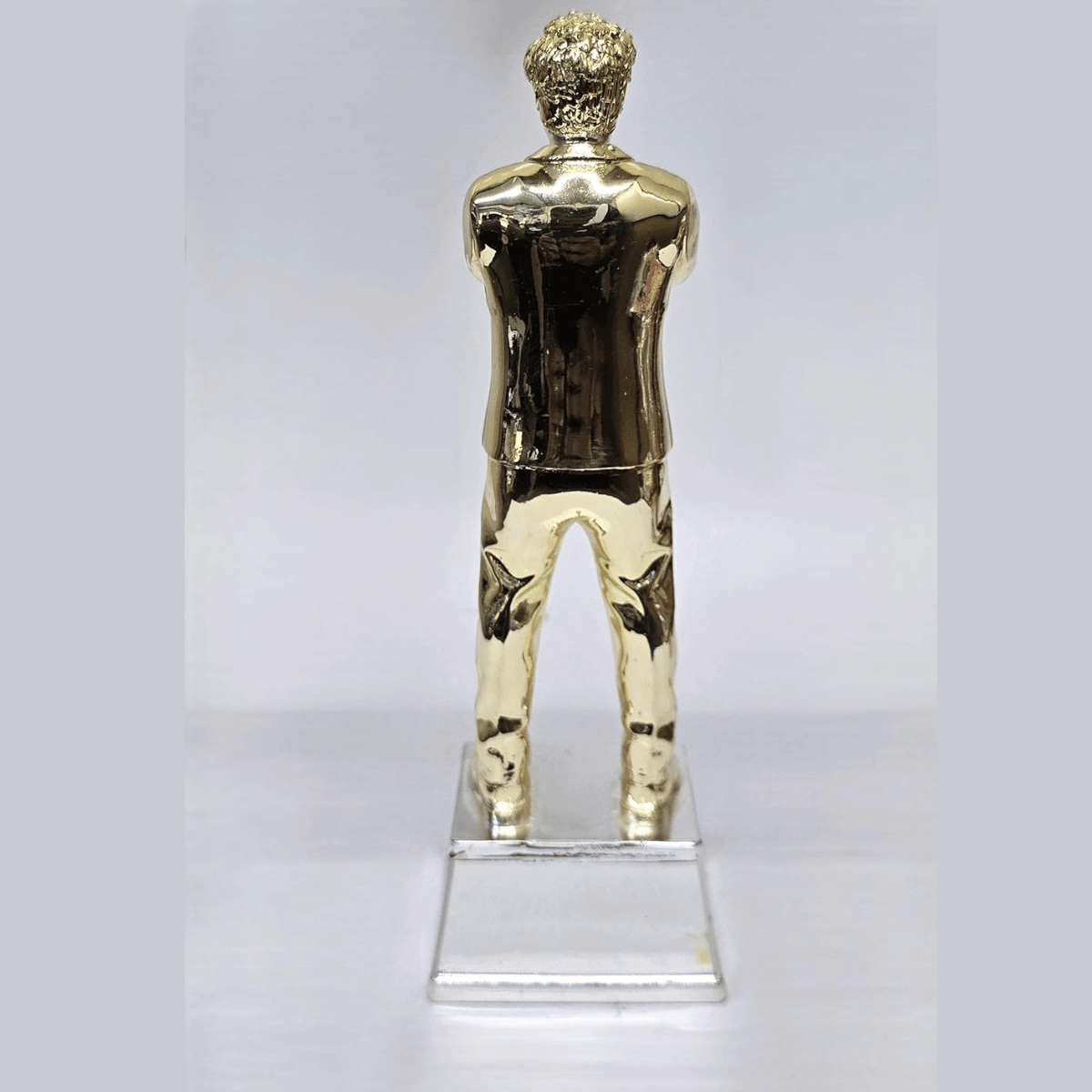 "Gold and silver-plated 'World's Best Dad' figurine, standing 9 inches tall with a 3-inch wide base, featuring a stylish man in a suit with crossed arms, ideal as a Father's Day or birthday gift."