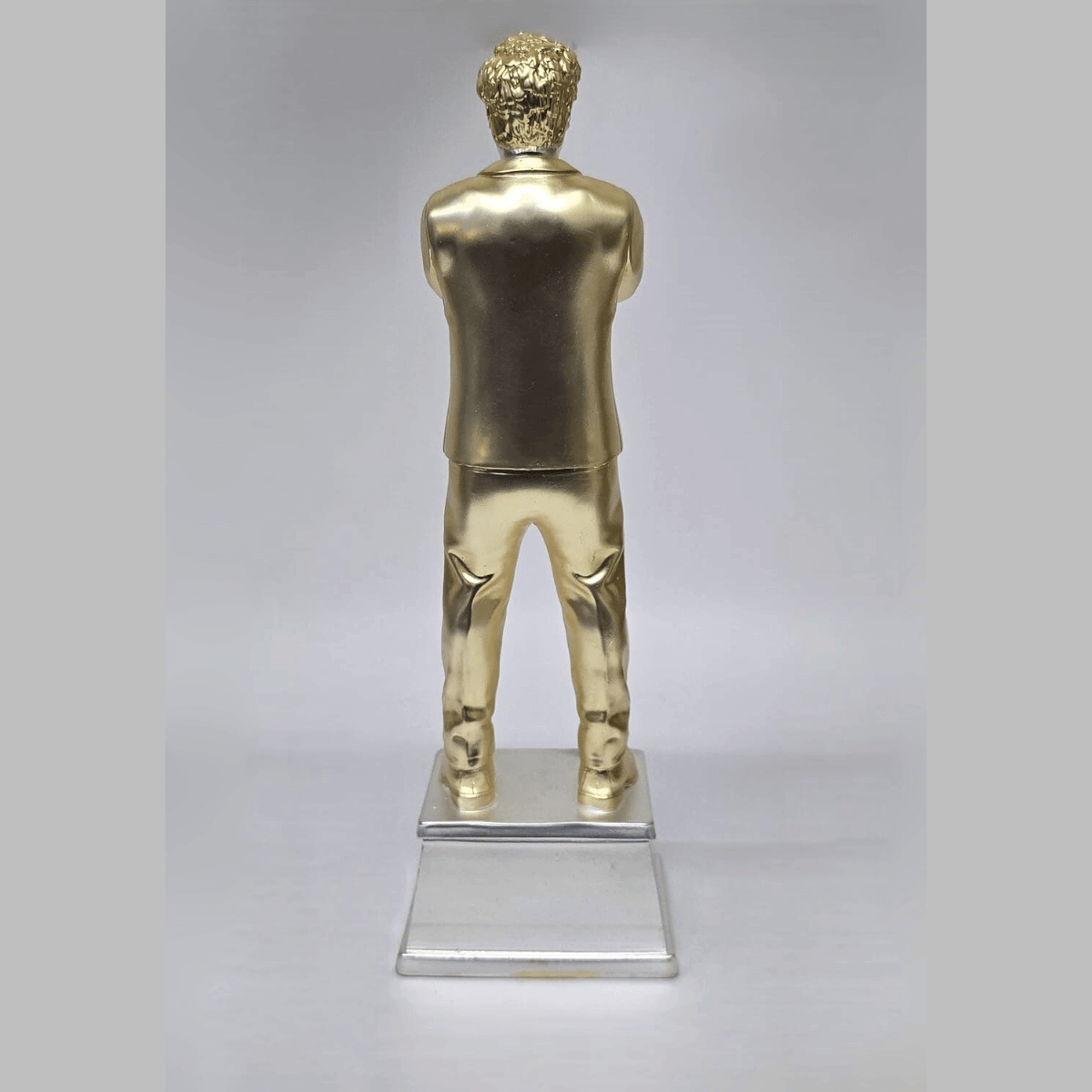 "Gold and silver-plated 'World's Best Dad' figurine, standing 9 inches tall with a 3-inch wide base, featuring a stylish man in a suit with crossed arms, ideal as a Father's Day or birthday gift."