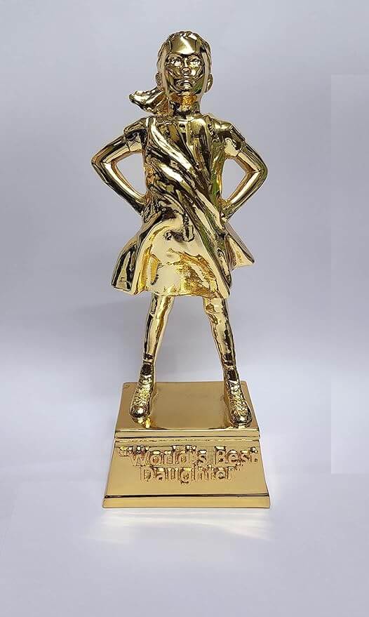 A gold-plated trophy featuring a young girl standing confidently with her hands on her hips. The figure has a determined expression, and her dress appears to be flowing. The trophy stands on a gold rectangular base with the inscription "World's Best Daughter.
