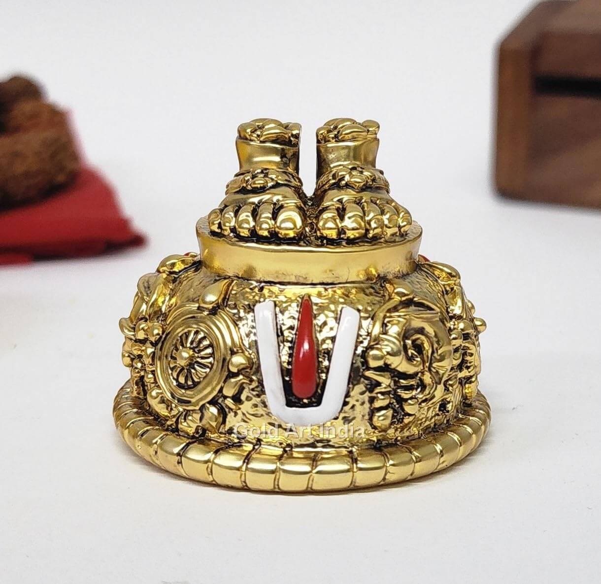 A gold Plated decorative idol featuring Lord Balaji's feet (Paduka) with intricate carvings of religious symbols and ornaments.