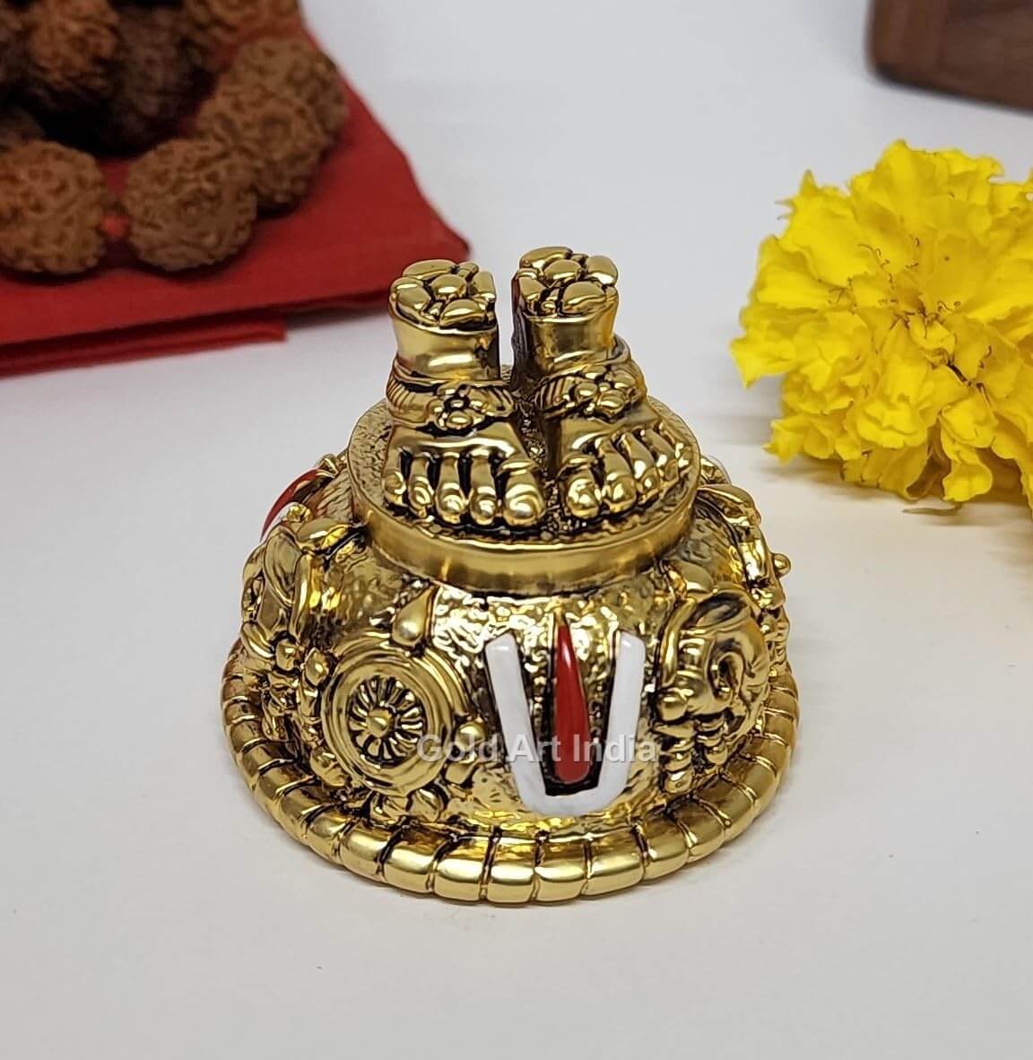 A gold Plated decorative idol featuring Lord Balaji's feet (Paduka) with intricate carvings of religious symbols and ornaments.