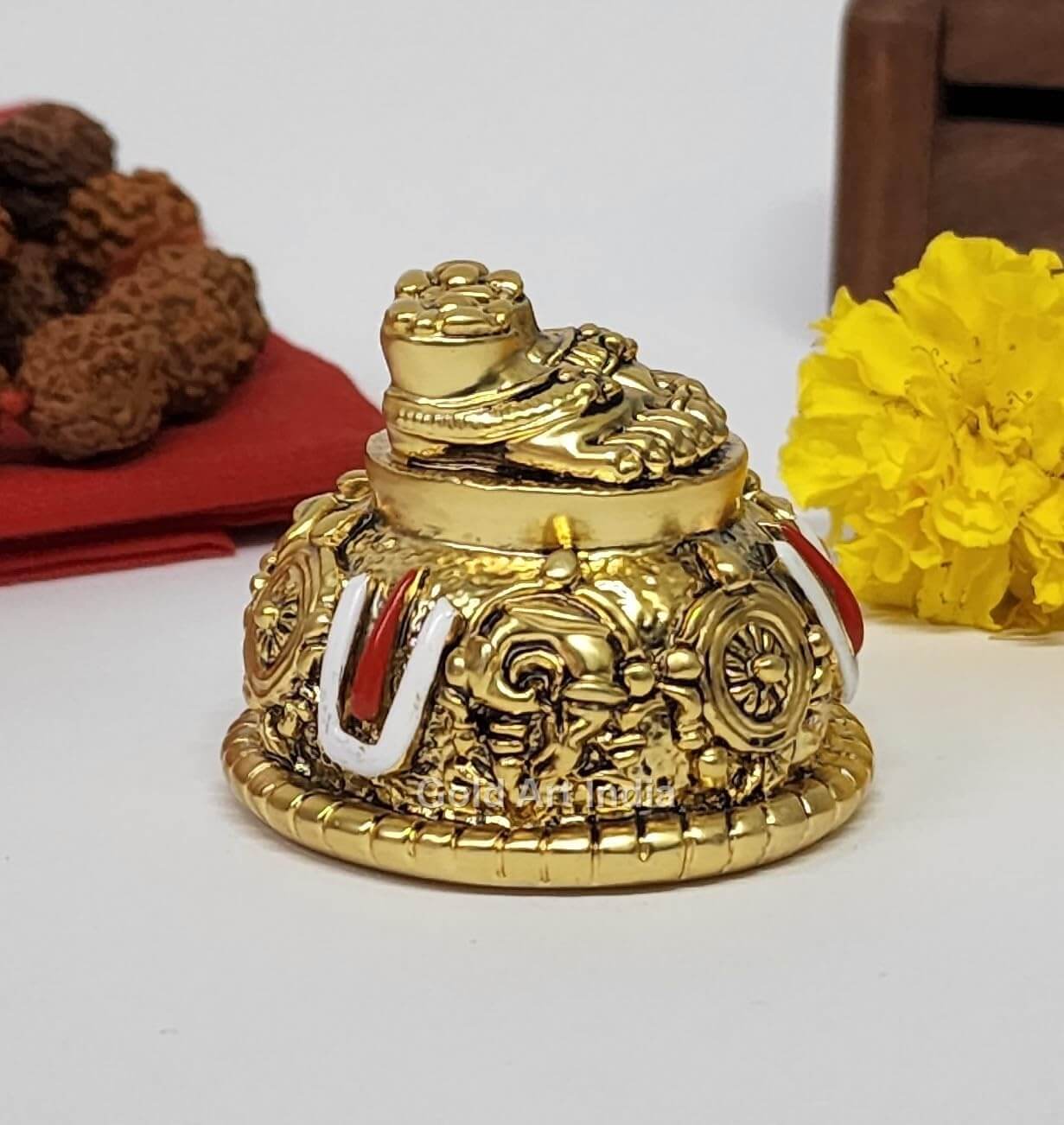 A gold Plated decorative idol featuring Lord Balaji's feet (Paduka) with intricate carvings of religious symbols and ornaments.