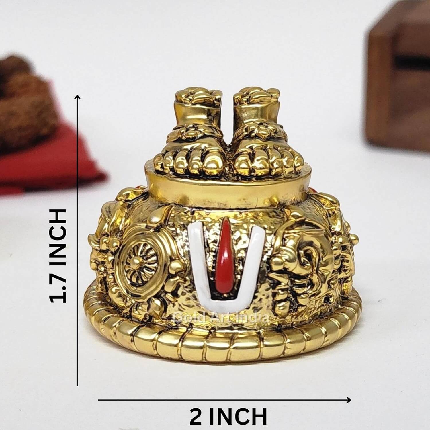 A gold Plated decorative idol featuring Lord Balaji's feet (Paduka) with intricate carvings of religious symbols and ornaments. size 2x1.7 inch