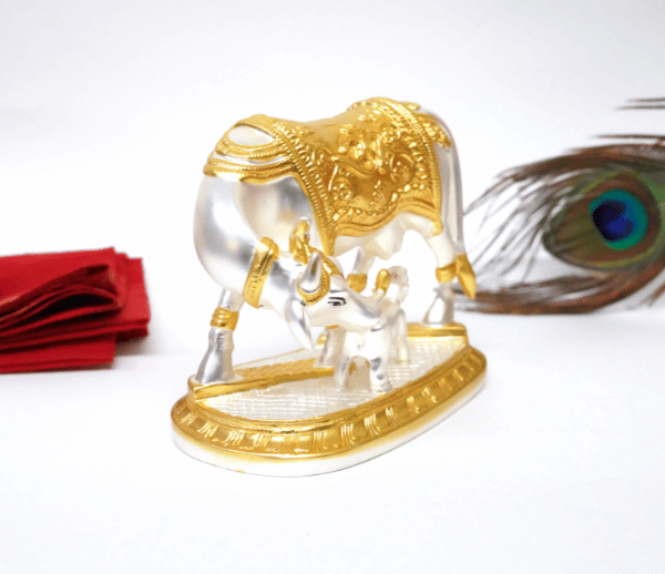 Elegant silver and gold Plated matte Kamadhenu cow and calf idol with intricate detailing, symbolizing prosperity and spiritual blessings. Perfect for home decor, puja rituals, and gifting
