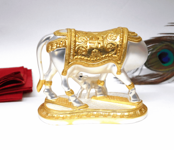 Elegant silver and gold Plated matte Kamadhenu cow and calf idol with intricate detailing, symbolizing prosperity and spiritual blessings. Perfect for home decor, puja rituals, and gifting