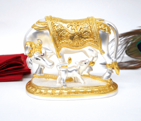 Elegant silver and gold Plated matte Kamadhenu cow and calf idol with intricate detailing, symbolizing prosperity and spiritual blessings. Perfect for home decor, puja rituals, and gifting