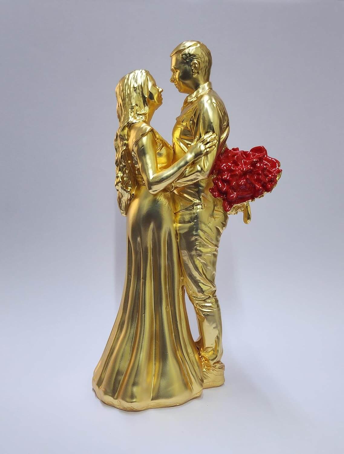 Gold-plated romantic couple figurine with a matte finish, holding a bouquet