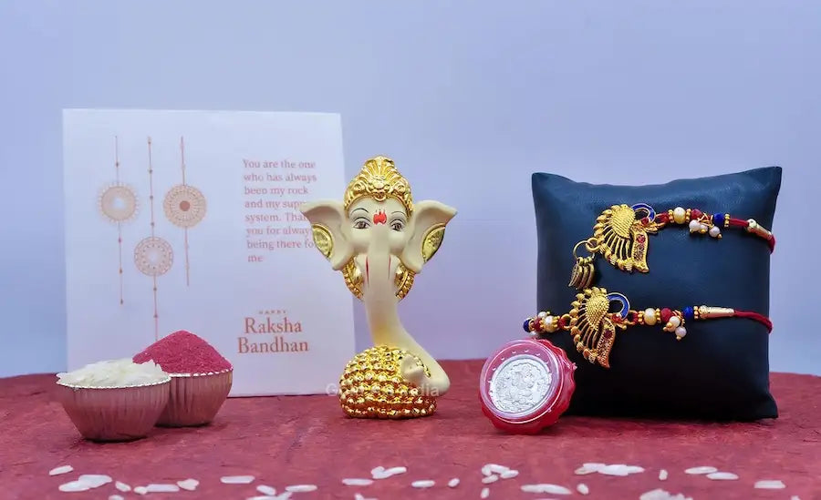 gold plated ladoo ganesh rakhi gift set