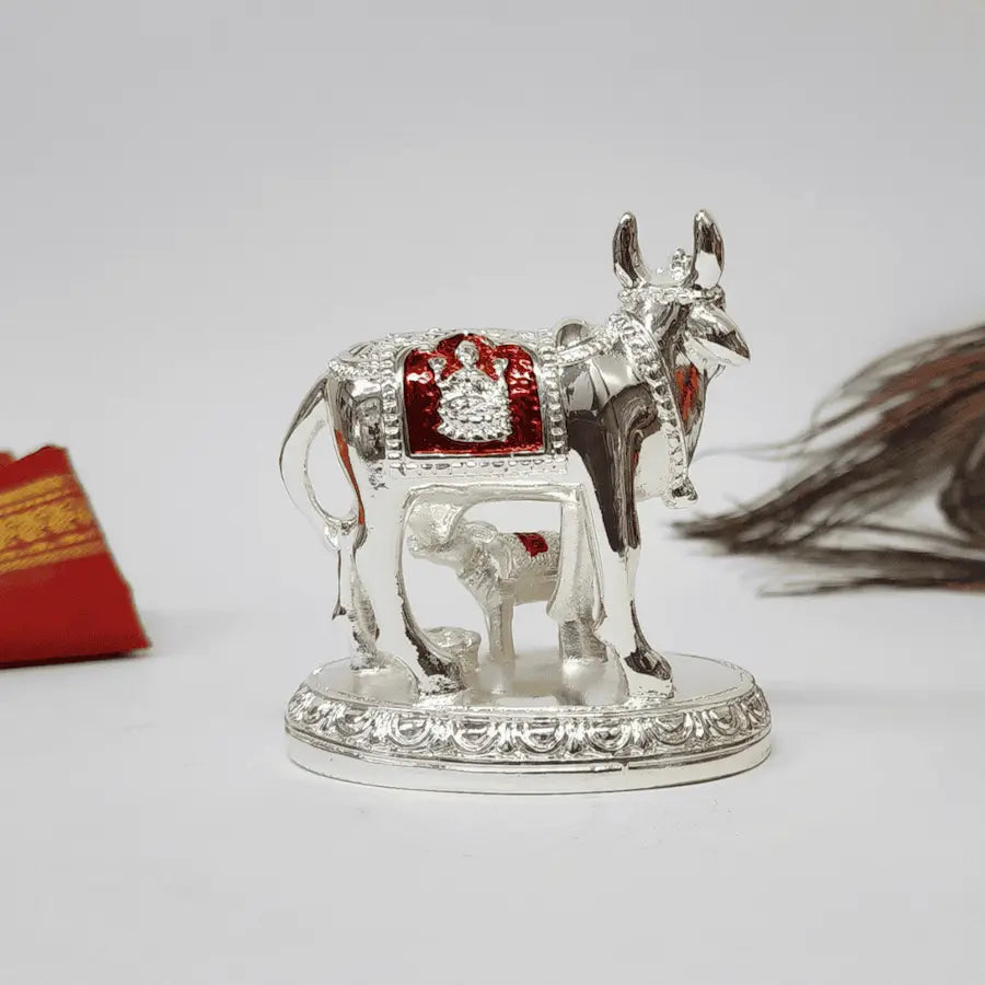 Kamdhenu Cow and Calf Idol, silver-plated with Goddess Laxmi symbol, symbolizing wealth and prosperity.