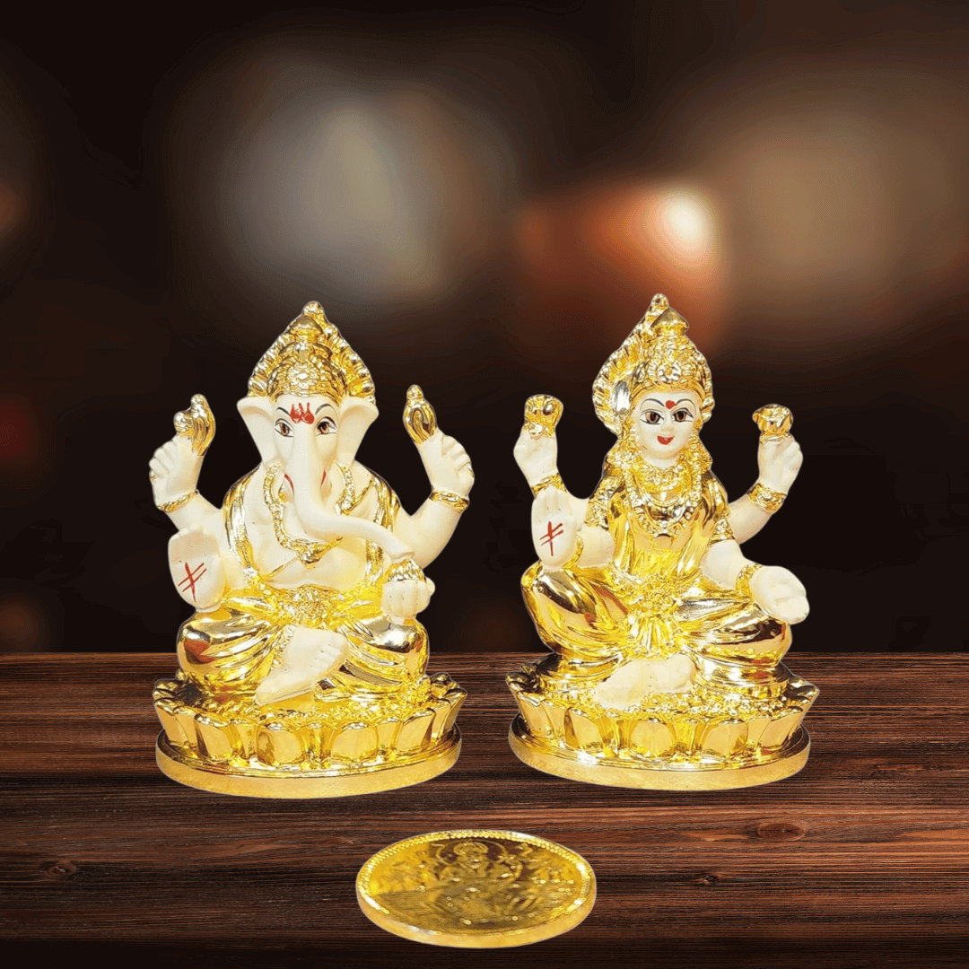 Laxmi Ganesh gold plated terracotta idol set on a wooden surface, symbolizing prosperity and spirituality.