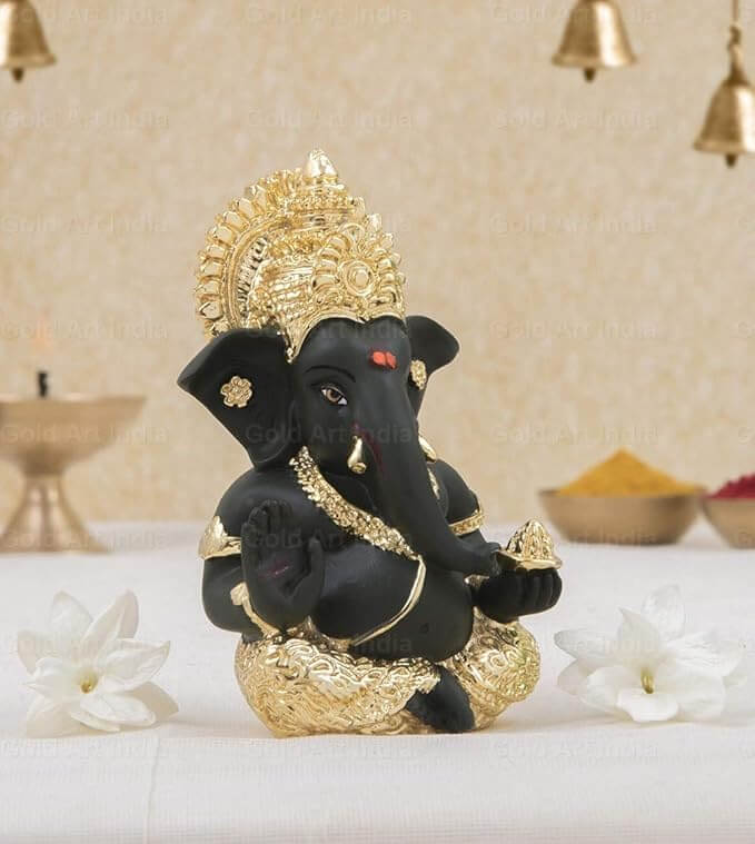 Black Ganesha idol with gold accents, perfect for home decor and gifting, showcasing detailed craftsmanship.