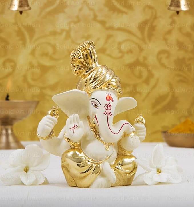 Gold plated off-white Ganesha idol, perfect for home décor and gifting during festivals.