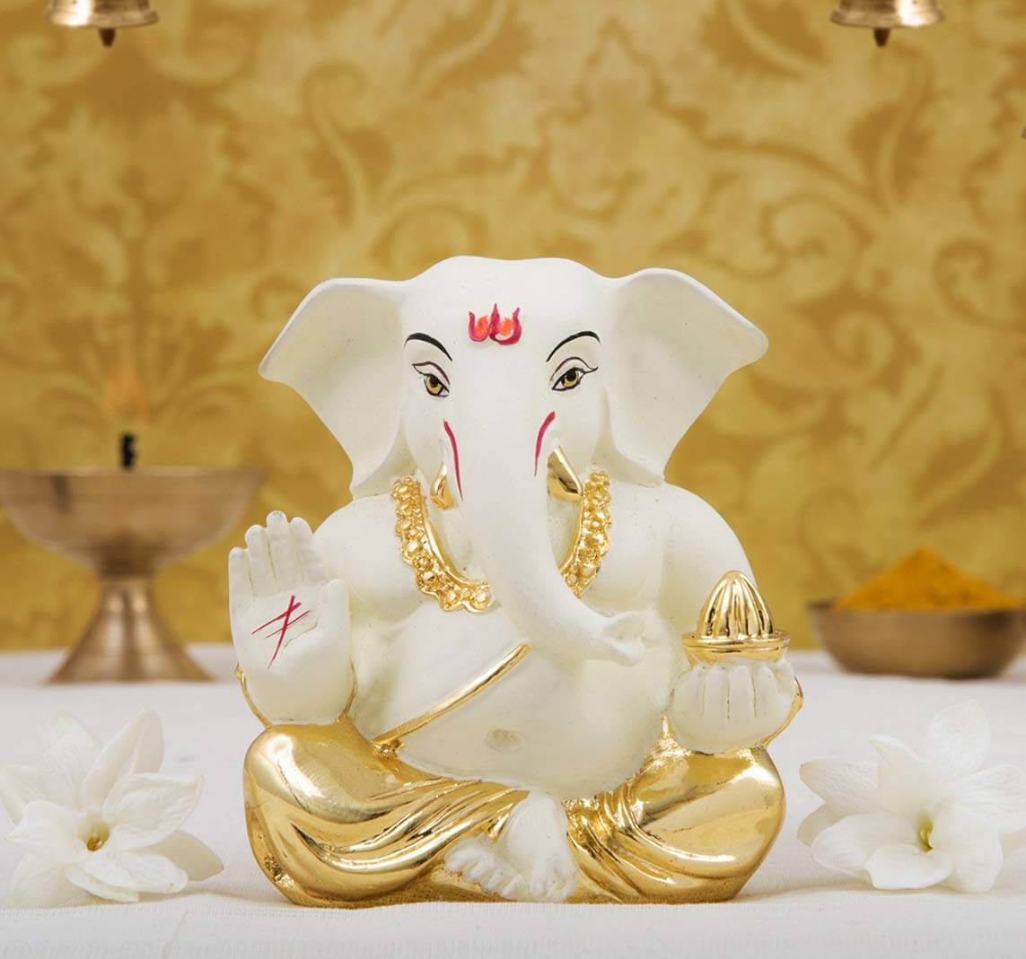 Gold plated off white terracotta Ganesha idol, perfect for home and car decor, ideal for gifts and festivals.