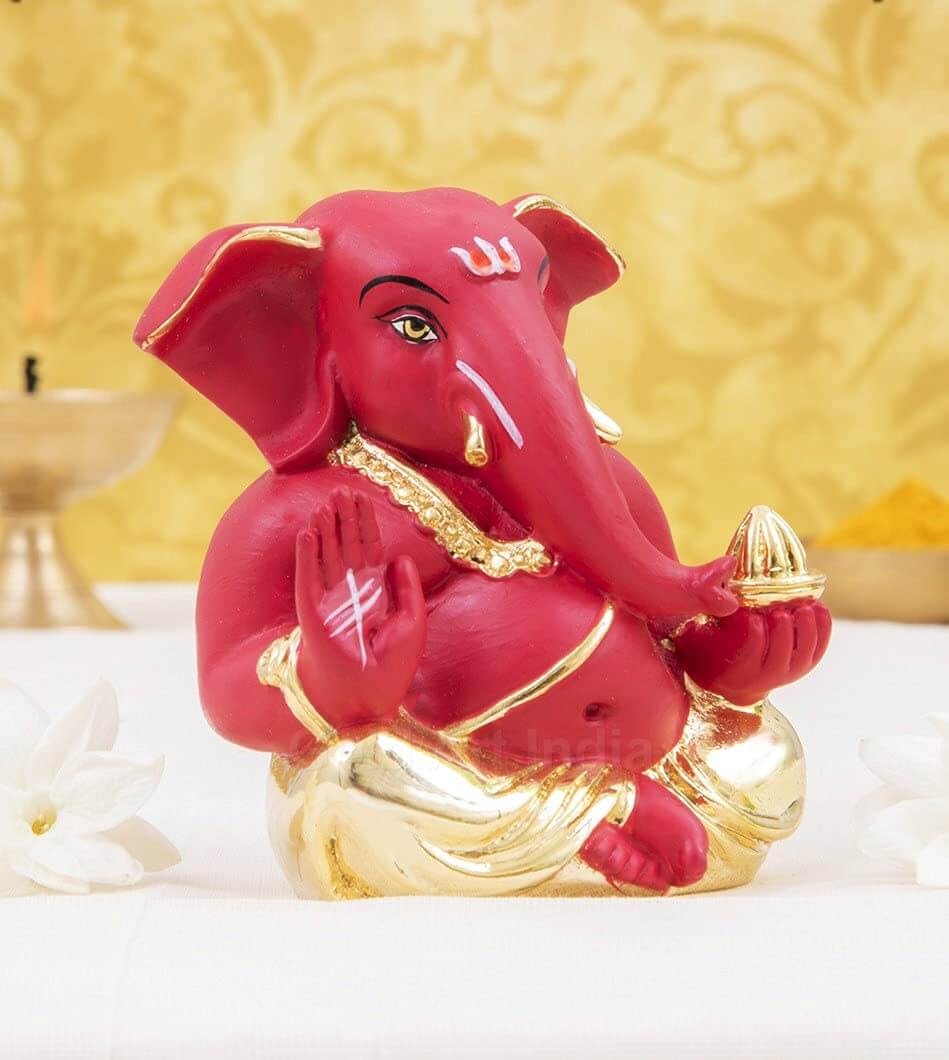 Gold plated red terracotta Ganesha idol, perfect for office and home decor, symbolizes prosperity and good fortune.
