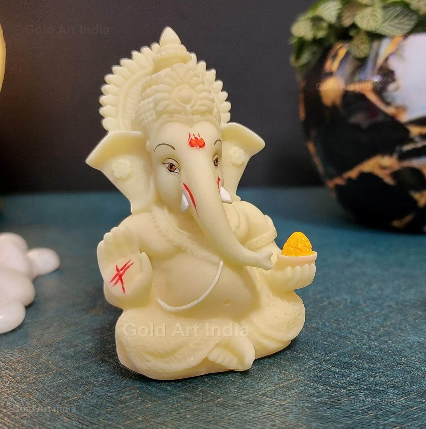 Ivory finish Ganesha idol made of solid polyresin, perfect for home decor and gifts, measuring 3.5 inches tall.