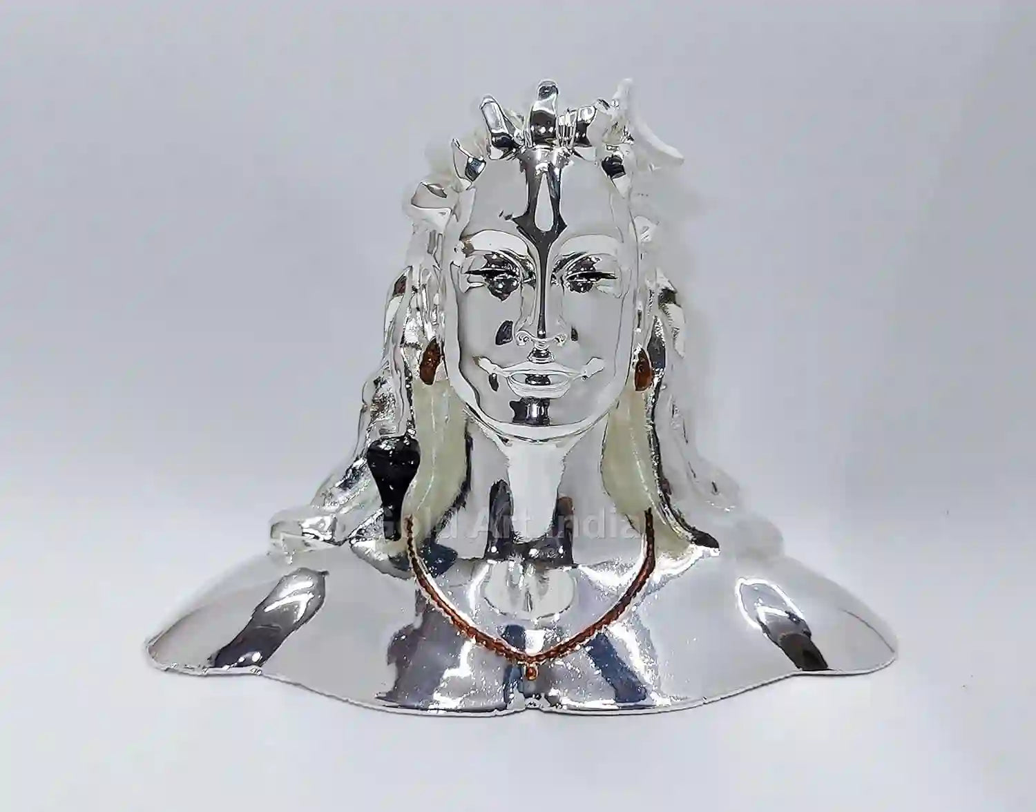 Adiyogi Shiva idol with silver plated finish โ front view on blue backdrop
