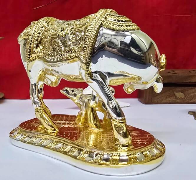 Kamdhenu Cow & Calf idol with Om symbol on red background