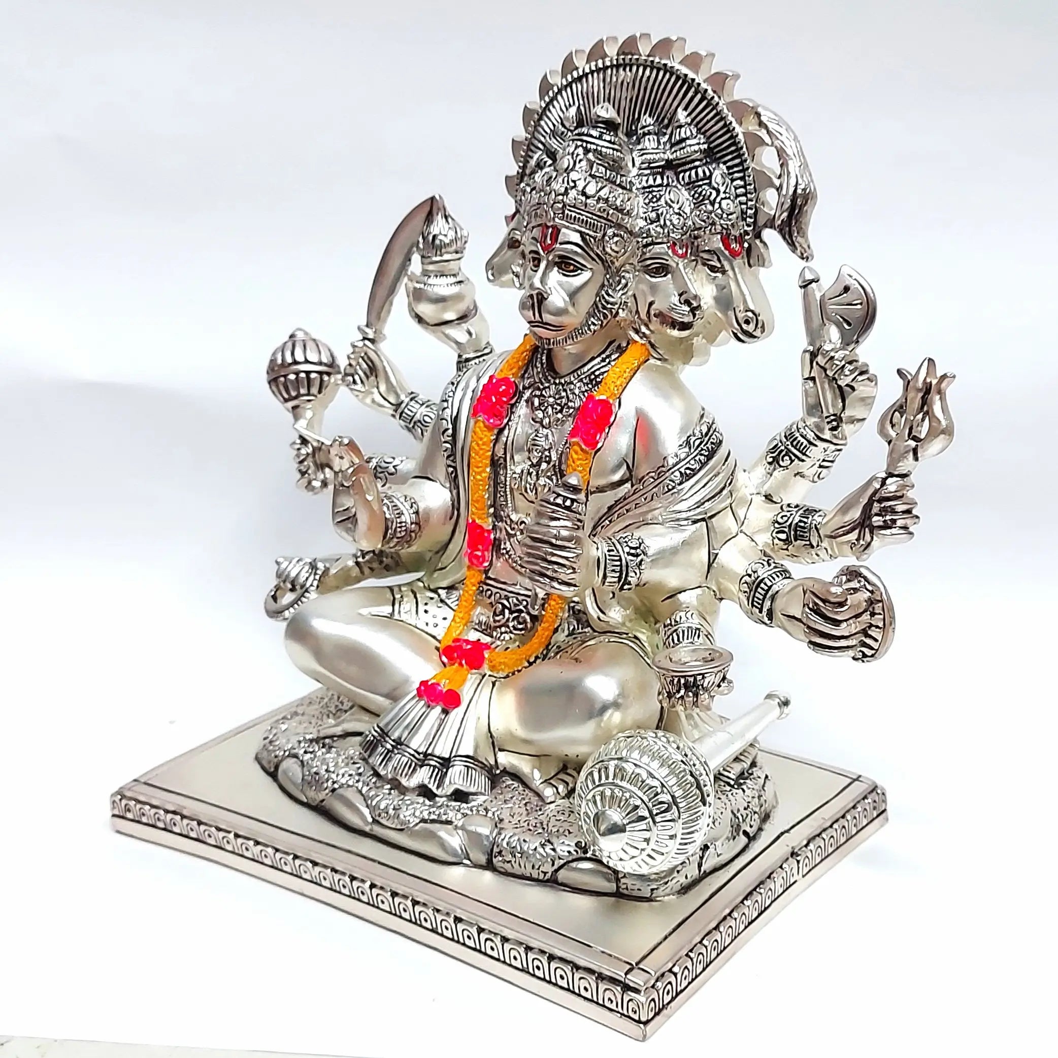 Silver plated Panchmukhi Hanuman idol with five faces and multiple arms holding divine weapons, side view.