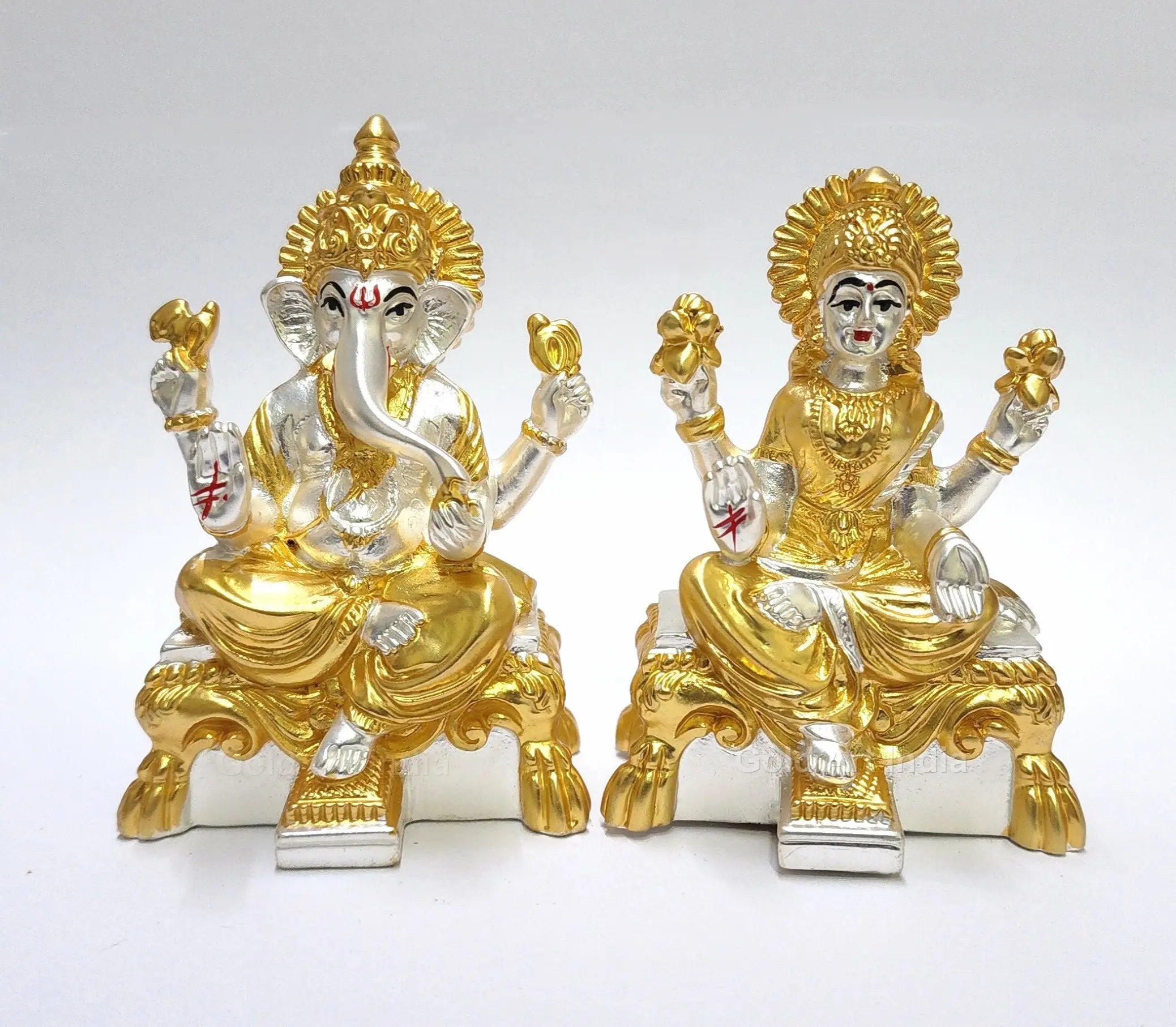 Front view of gold and silver plated Laxmi and Ganesha idols on ornate peeth base by Gold Art India, matte finish