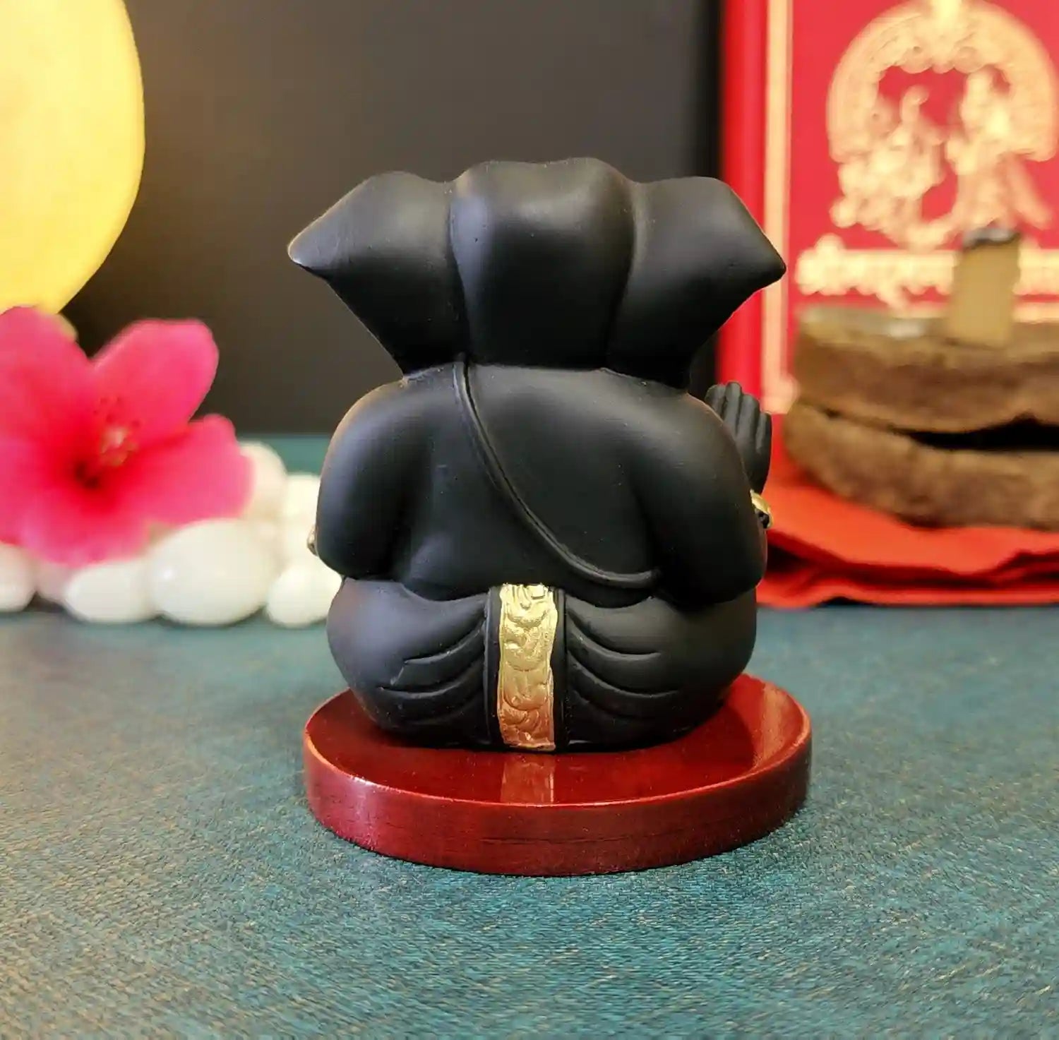 Back view of Black Terracotta Finish Ganesha Idol with Golden Detailing on Wooden Base