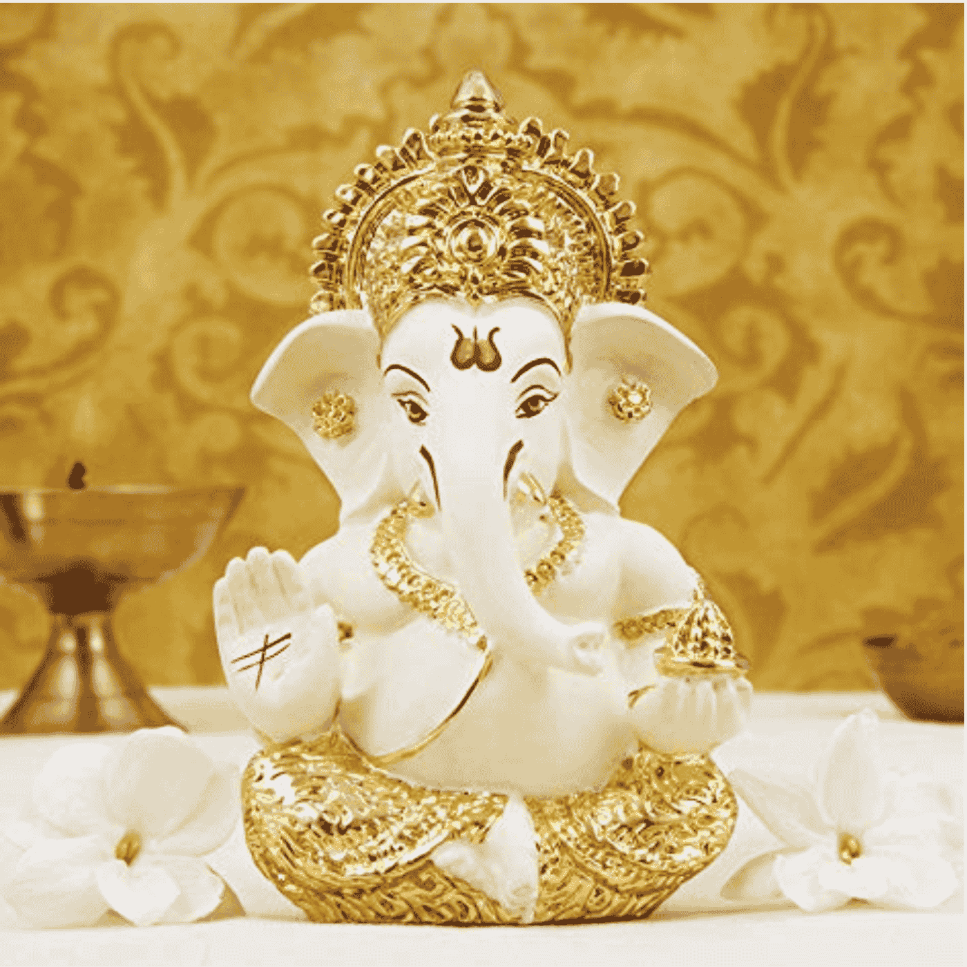 Front view of a Ceramic and gold Plated Ganesha idol, with intricate gold detailing and a blessing hand.