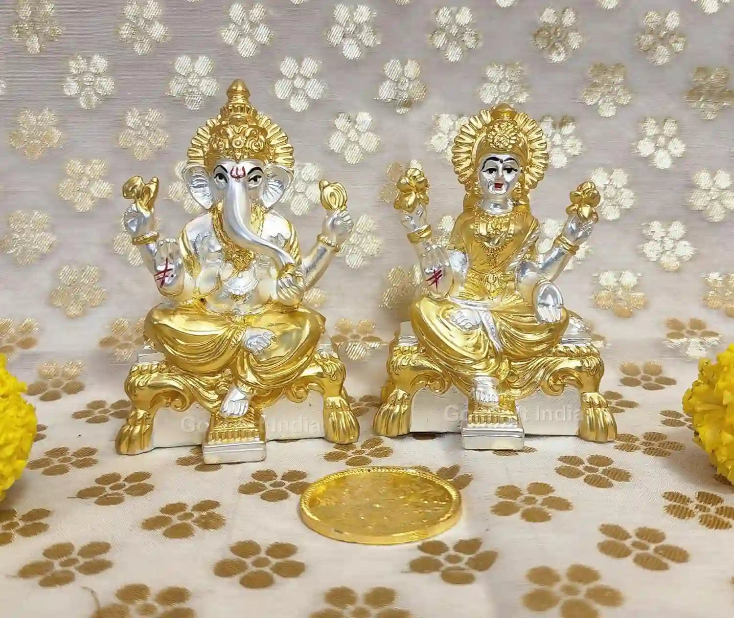 Close-up view of Lakshmi and Ganesha idols crafted in resin with authentic gold and silver plating, matte finish detailing 