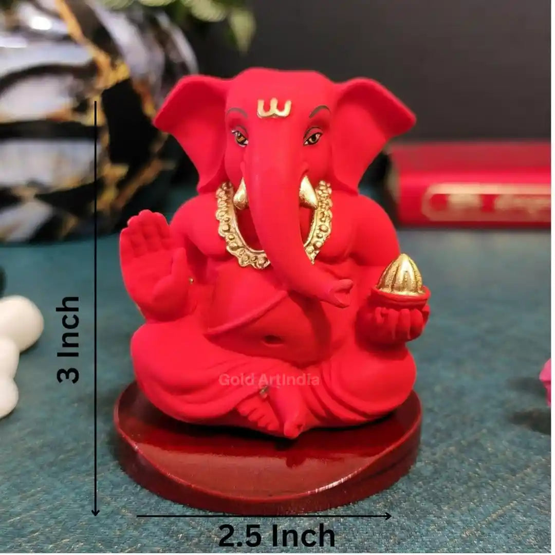 Compact red Ganesha idol with golden accents, 3 inch height and 2.5 inch width – size reference