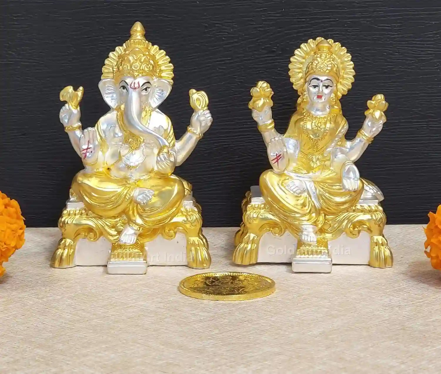 Front view of Lakshmi and Ganesha resin idol set with gold and silver plating, displayed with gold-plated coin on base